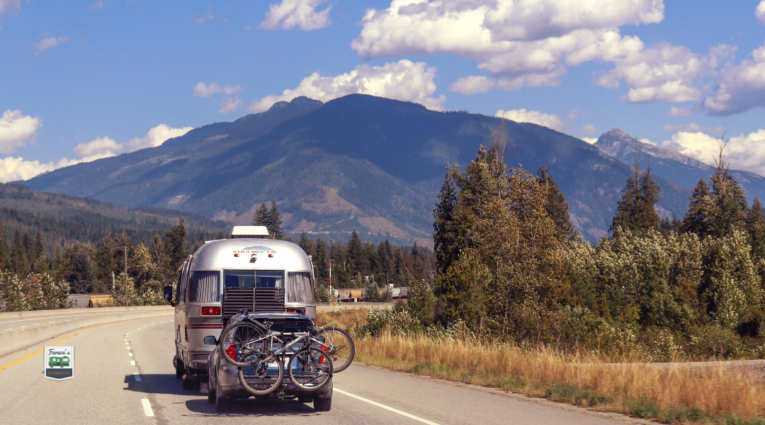 Family safely exiting an RV on the side of a California highway with hazard lights on