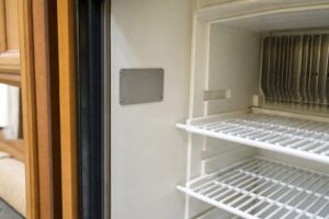 Location of the model and serial data plate on an RV absorption refrigerator.